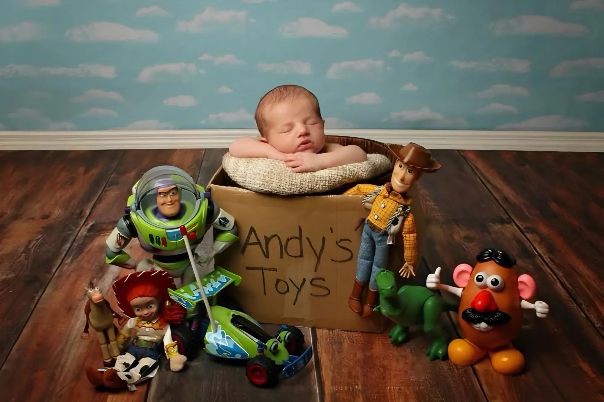 Baby in a toy crate surrounded by colourful toy characters