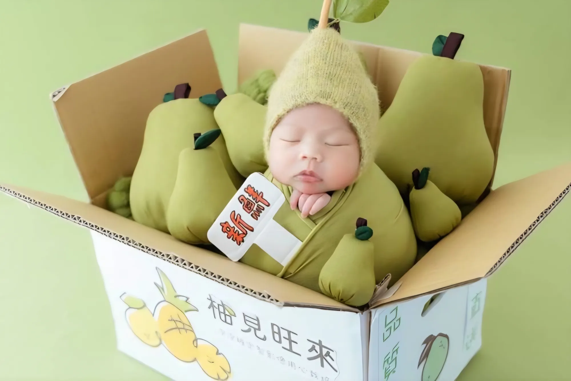 Sleeping baby in a fruit box surrounded by yellow fruit props